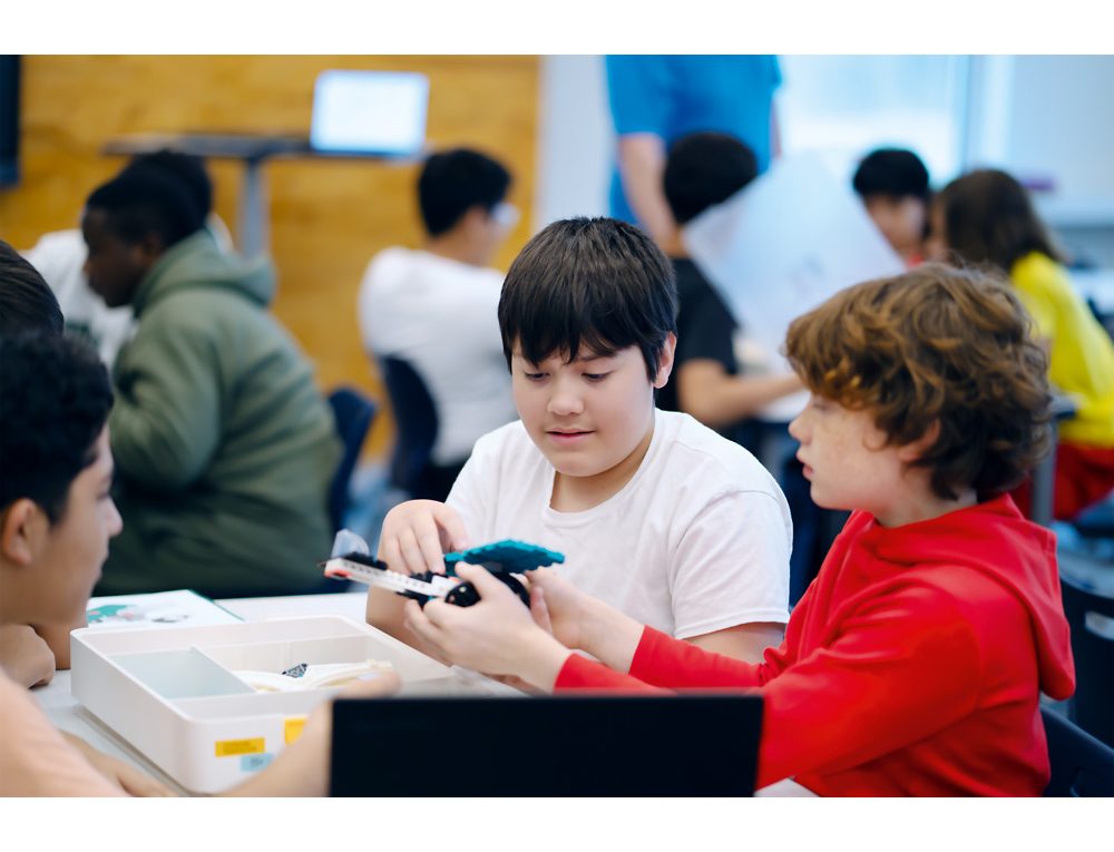 Elever bygger tillsammans en LEGO® Education-modell under en praktisk och inkluderande läraktivitet i klassrummet.