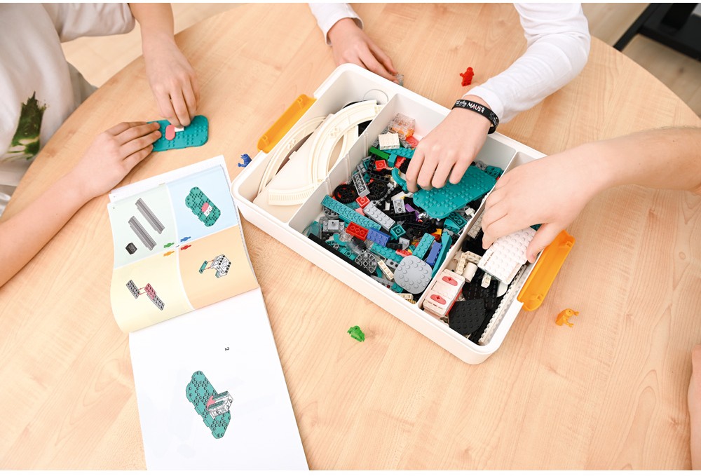 Elever väljer byggdelar ur en LEGO® Education-låda och bygger modeller med hjälp av visuella instruktioner.